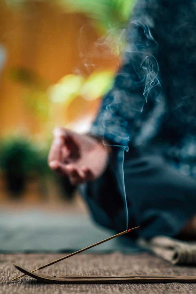 A burning incense stick with smoke has a spiral shape A burning incense stick with smoke has a spiral shape.