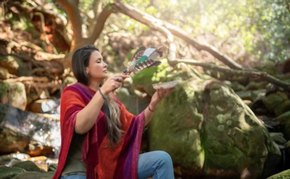 Woman doing purification ritual with incense.