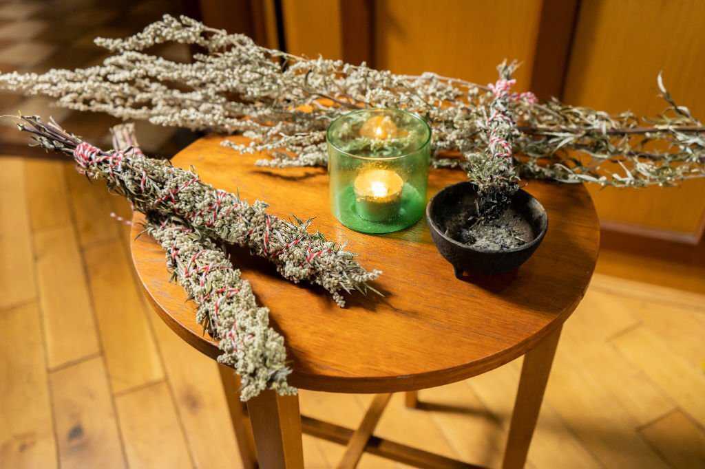 A bunch of mugwort incense is placed on the table.